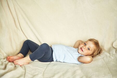 portrait of a funny little model girl. child playing at home.の写真素材