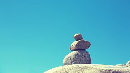 stacked stones for orientation in the mountains on sky background.の写真素材