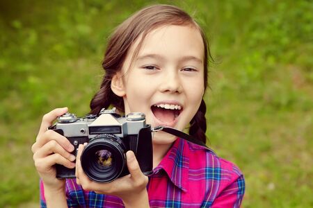 teenage girl with a camera. old photo camera. youth lifestyle.の写真素材