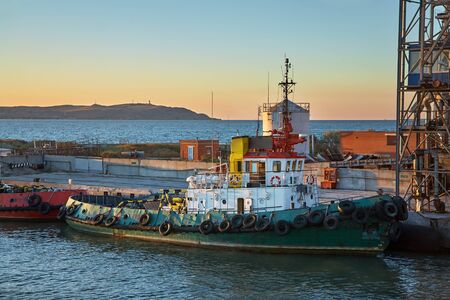 Ships in a cargo seaport at sunsetの写真素材