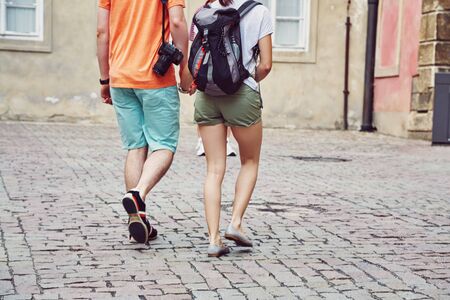 young couple travelers walking on a street of European cityの写真素材