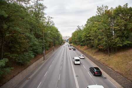 motorway out of city. going cars on the road.の写真素材