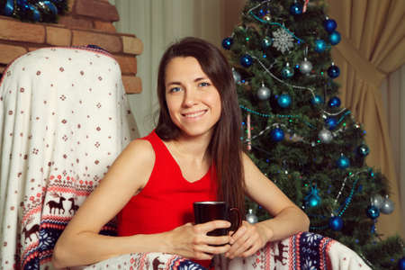 woman with a book and mug in rocking chairの写真素材