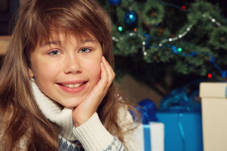 portrait of a teenage girl near Christmas treeの写真素材