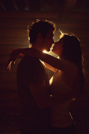 couple in love. Kissing man and woman at home in intimate atmosphereの写真素材