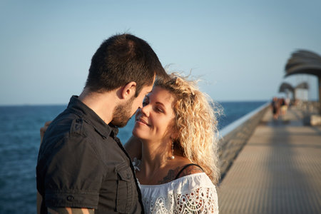 couple in love walking on sea shoreの写真素材