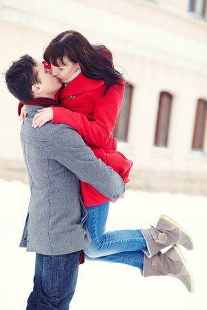 Young happy couple in love outdoors. loving man and woman walking in a city.の写真素材