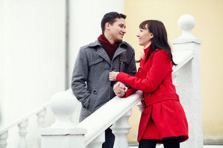 Young happy couple in love outdoors. loving man and woman walking in a city.の写真素材