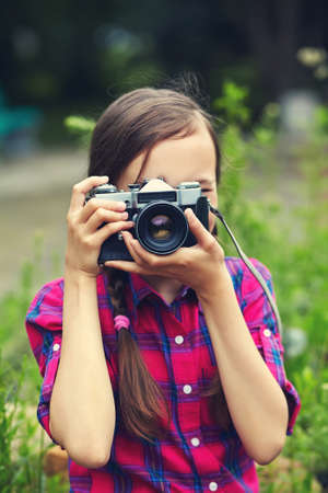 teenage girl with a camera. old photo camera. youth lifestyle.の写真素材