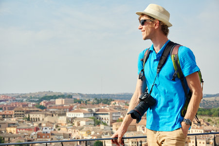 man traveler in a hat with a backpack and cameraの写真素材