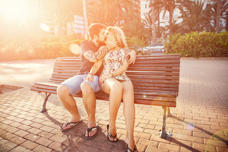 happy kissing couple in love. loving embracing man and woman in a street.の写真素材