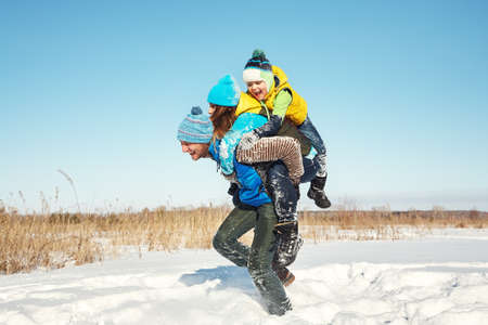 happy playing family in the winter. people outdoorsの写真素材