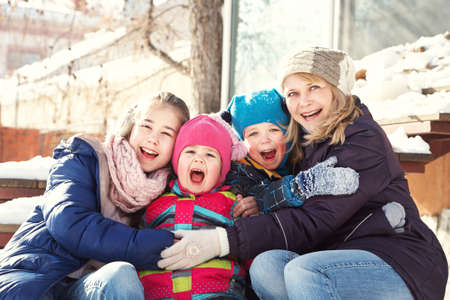 portrait of a family near a house in the winter outdoorsの写真素材