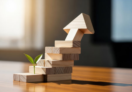 Steps to success with green sprout growing up on wooden blocksの素材