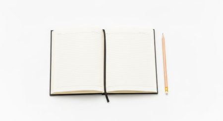 Notebook and pencil isolated on white background. Top view with copy spaceの素材