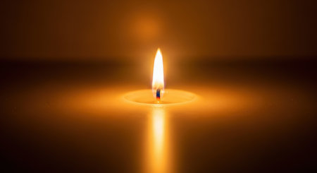 Burning candle on a dark background. Shallow depth of field.の素材