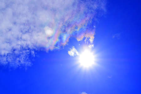 Sunny background, blue sky with white clouds and sunの写真素材