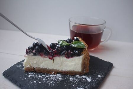 tea with blackcurrant and mint cheesecakeの写真素材
