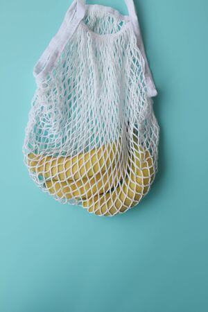 String Bag, Reusable Shopping Tote for Grocery with Bananas On A Blue Background. Environmentaly Friendly Lifestyle Concept. Zero wastem. Top view.の写真素材