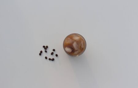 Iced coffee in a glass. Coffee beans.の写真素材