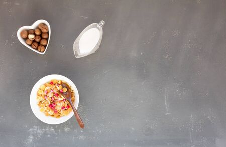 Pancake cereals with redcurrant berries macadamia nuts and milk.の写真素材