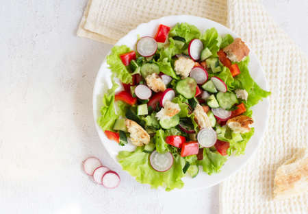 Flatlay. Fattoush salad with vegetables and toasted pita bread on a napkinの写真素材