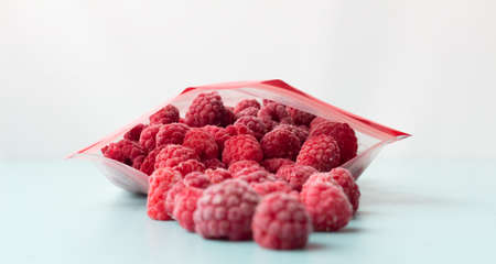 frozen raspberries in a plastic bag with a fastener.の写真素材
