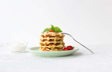 Vegetarian zucchini waffles in a stack, decorated with basil.の写真素材