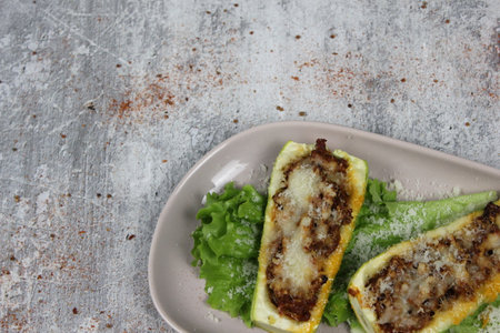 Baked zucchini stuffed with minced meat and cheese on a plateの写真素材