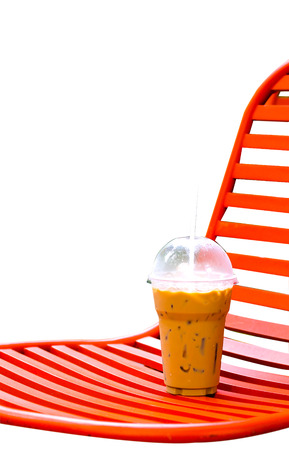 coffee drink on orange chair isolated white backgroundの写真素材