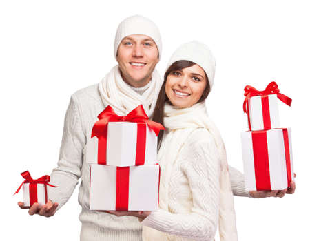 Young couple with Christmas gifts isolated on white backgroundの写真素材