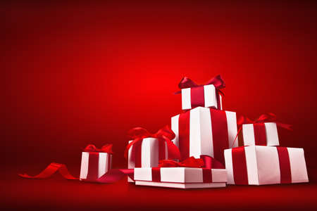 Christmas gifts with red bows and ribbons on red backgroundの写真素材