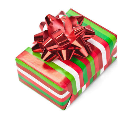 Christmas gift in colorful paper with red bow isolated on whiteの写真素材