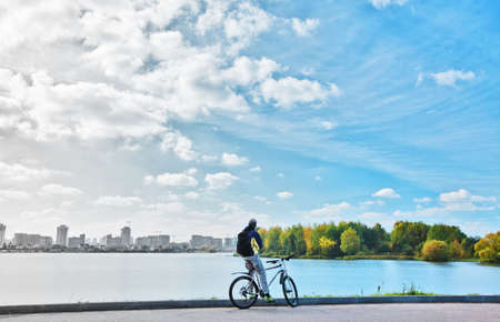Cyclist between polluted city and nature. Ecology conceptの写真素材