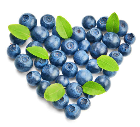 Fresh blueberries with green leaves isolated on whiteの写真素材