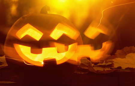 Jack O Lantern halloween pumpkin at sunsetの写真素材