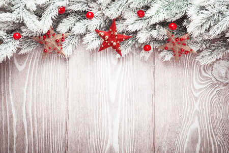 Christmas decorations with stars and snow on wood backgroundの写真素材