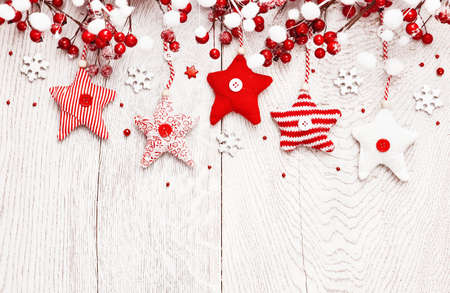Christmas decoration with red stars and snowflakes on white wood backgroundの写真素材