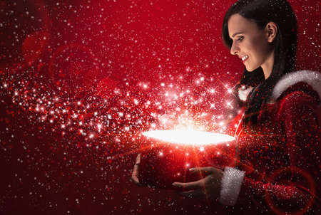 Beautiful girl with christmas magic box