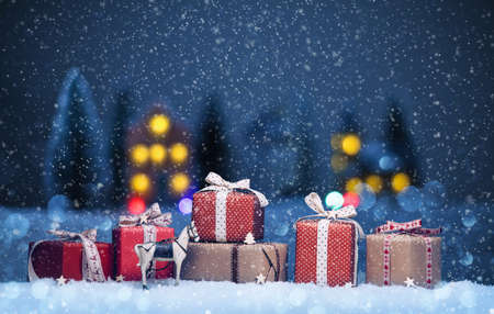 Night landscape with gifts and snow. Christmas backgroundの写真素材