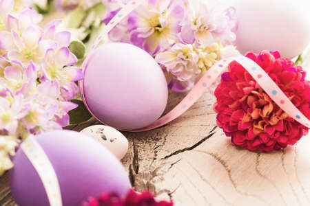 Easter decoration with eggs and spring flowers on wood backgroundの写真素材