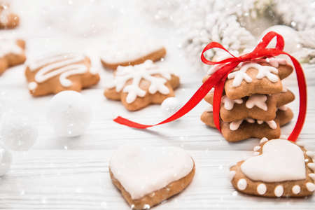 Christmas cookies with red ribbon and bow on white backgroundの写真素材