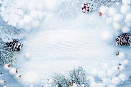Christmas decoration with branches of spruce and pine cones in snow
