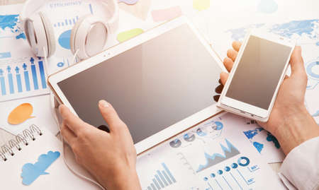 Businesswoman uses new devices to work successfullyの写真素材