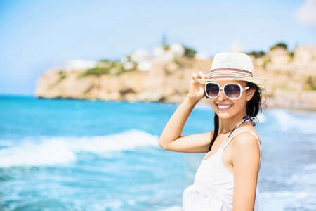Beautiful girl on the beach at sunsetの写真素材