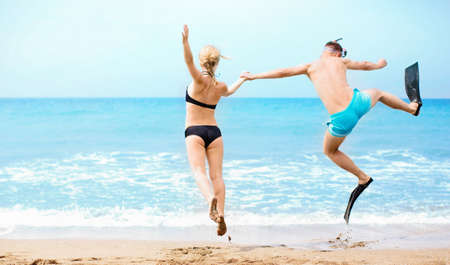 Happy couple jumping in the seaの写真素材