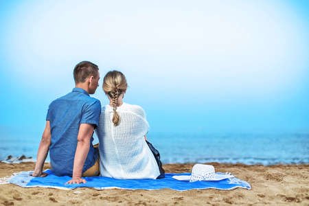 Young couple enjoying romantic evening on the beachの写真素材