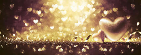 Hearts On Shiny Gold Backgroundの写真素材