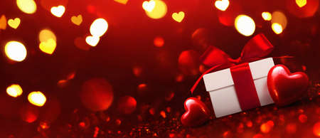 Gift with Hearts on Red Background. Holiday Decoration to Valentine's Dayの写真素材