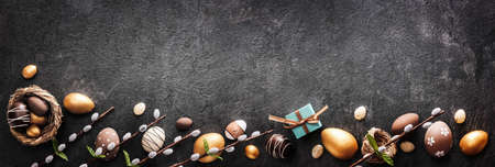 Easter decoration. Golden eggs on dark shale backgroundの写真素材